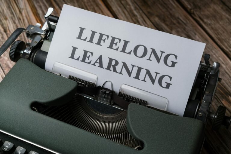 A classic typewriter displaying 'Lifelong Learning' on paper, symbolizing ongoing education.